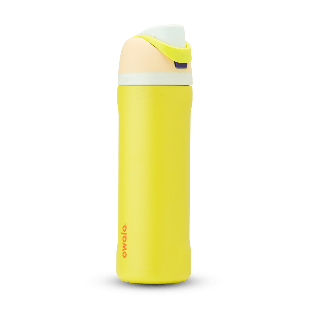 FreeSip 24oz in Lemon Limeade, bright yellow body with peach lid, neon yellow-green carry loop, white accent band, and orange logo