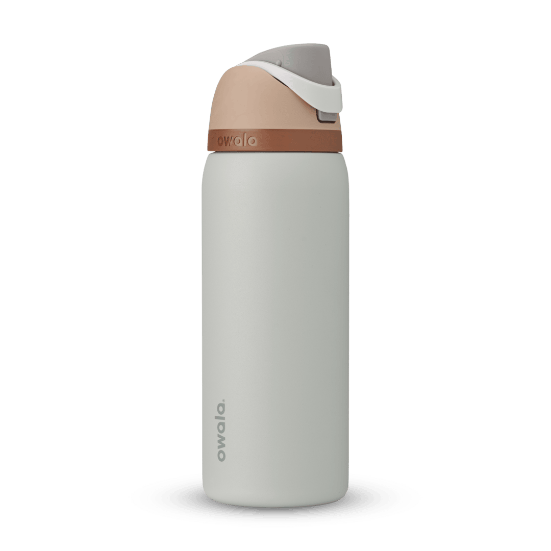 FreeSip 32oz water bottle, pale cool gray body with warm copper-tan band and blush top lid, flip cap