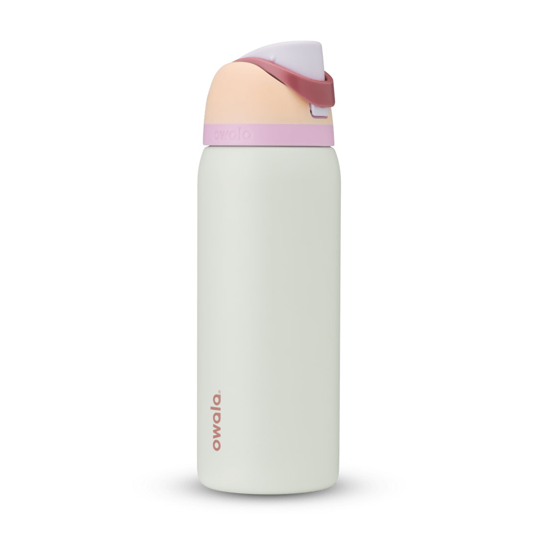 FreeSip 32oz water bottle, off-white body with blush peach lid base and soft pink carry loop