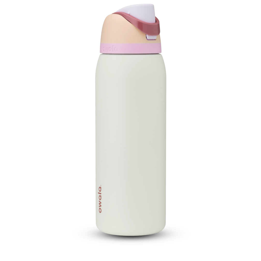FreeSip 40oz in Coastal Mist, pale mint green body with peach flip cap, dusty rose carry loop, and pink accent band