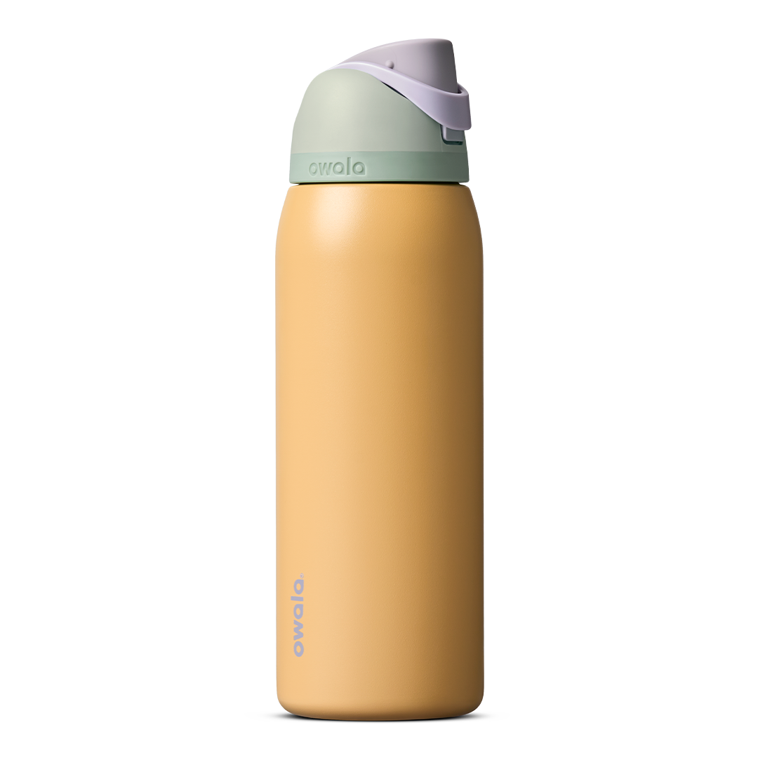 FreeSip 40oz in Beachfront, warm golden yellow insulated bottle with mint green accent band, lavender flip cap, and lavender carry loop