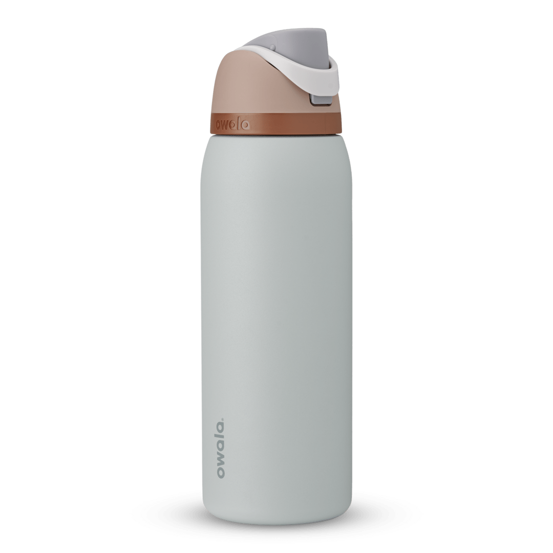 FreeSip 40oz in Calm Waters, pale gray-blue body with peach flip cap, white carry loop, and copper accent band