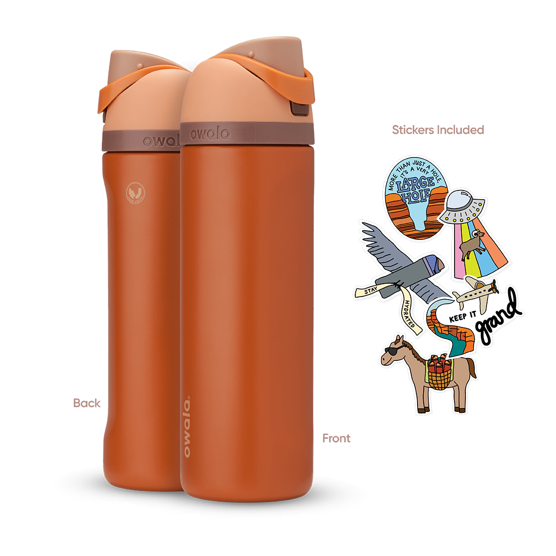 Great American Road Trip FreeSip 24oz in Grand Canyon, warm terracotta-orange body with peach flip cap, mauve carry loop, and brown lid accent band; back and front views shown with included national park-themed stickers featuring an eagle, horse, UFO, and "Keep It Grand" rainbow