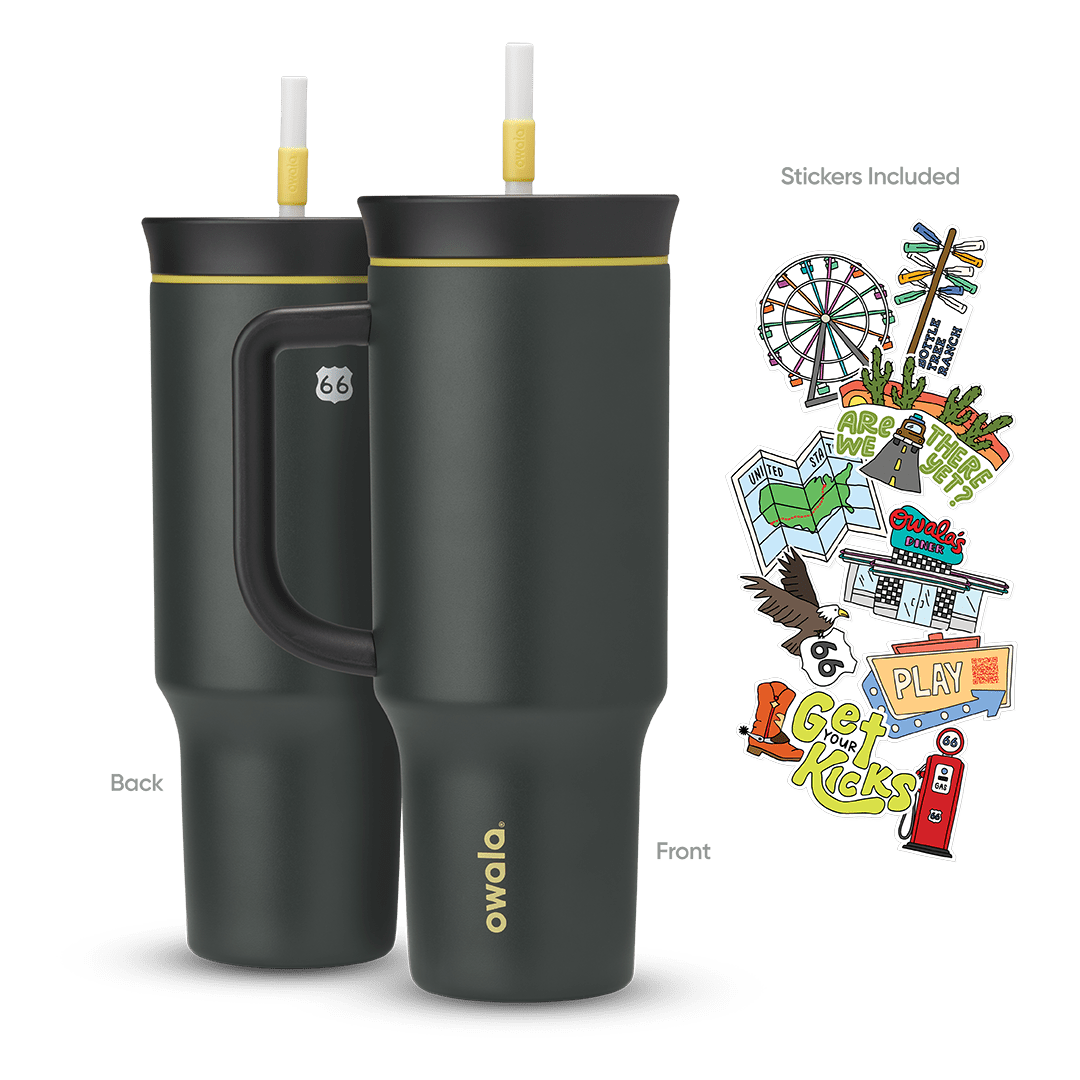 Great American Road Trip Tumbler 40oz in Route 66 (dark charcoal-black body and handle with yellow accent ring and white straw), back and front views shown with included Route 66-themed stickers featuring a Ferris wheel, motel signs, gas pump, and roadside icons