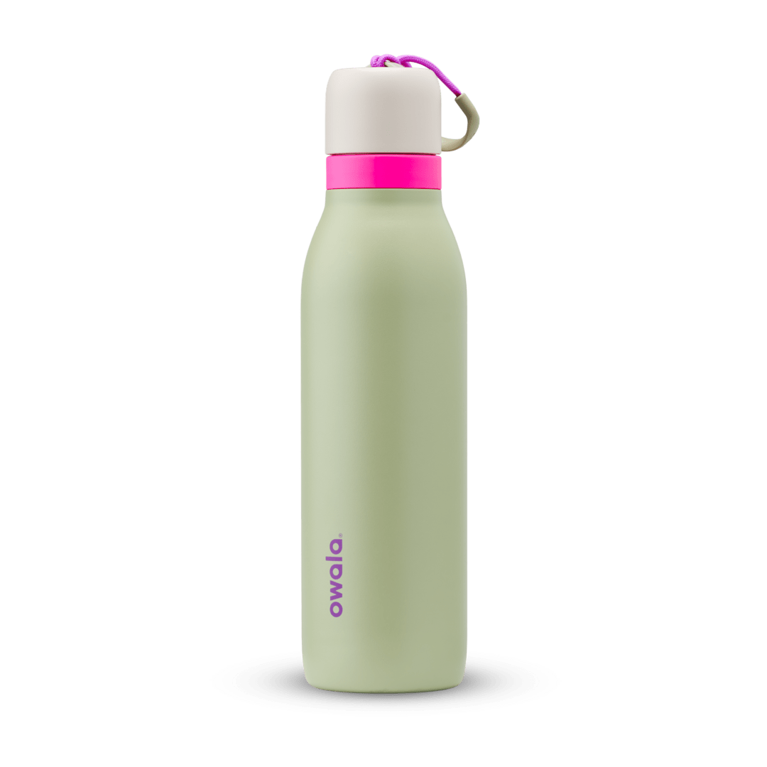 FreeSip Twist 18oz in Neo Sage, sage green insulated water bottle with cream twist cap, hot pink twist cap accent band, magenta carry string, and purple Owala logo