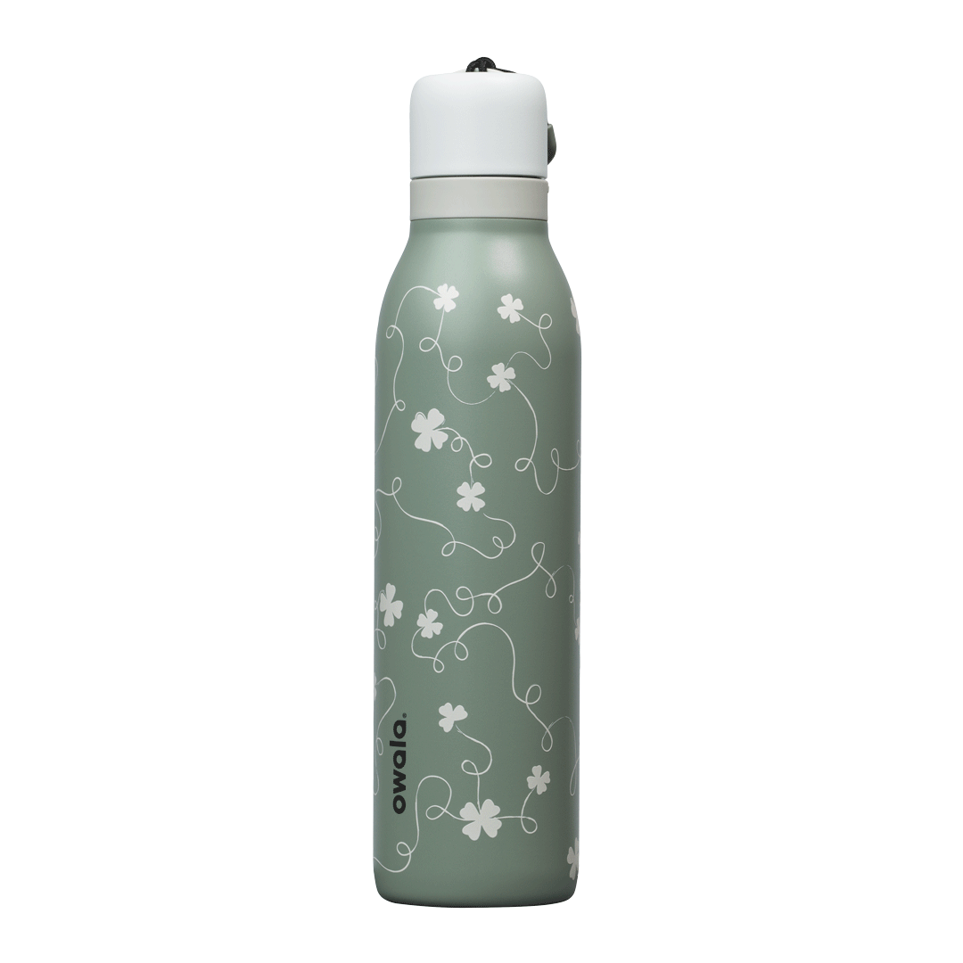 Owala RS: Clover Achiever FreeSip Twist 24oz bottle in sage green with subtle white four-leaf clover pattern; white twist-off lid; animated 360-degree spin view