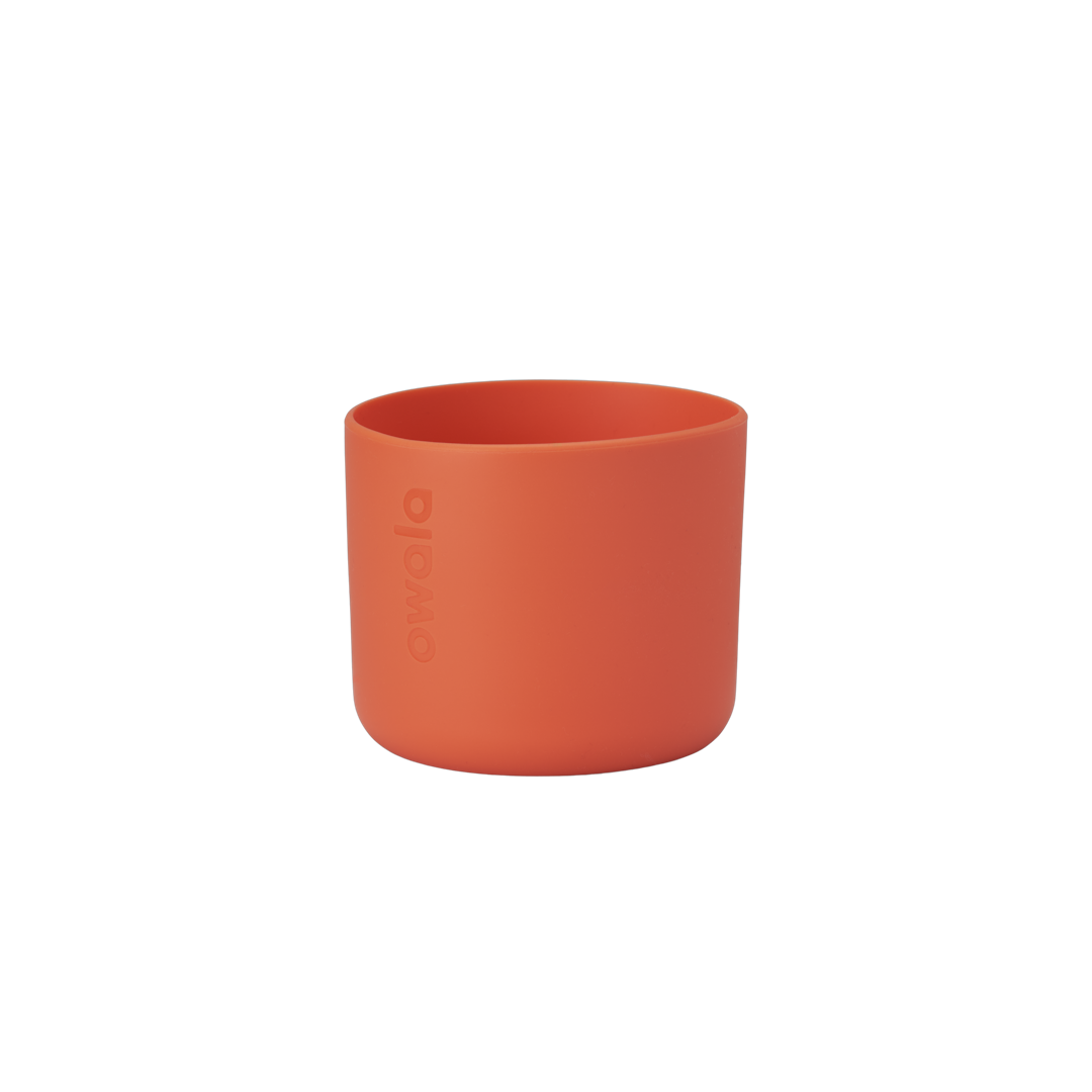Owala Bottle Boot in bright tangerine orange silicone with tonal Owala logo, short cylindrical form sized for 16oz Kids' FreeSip bottles