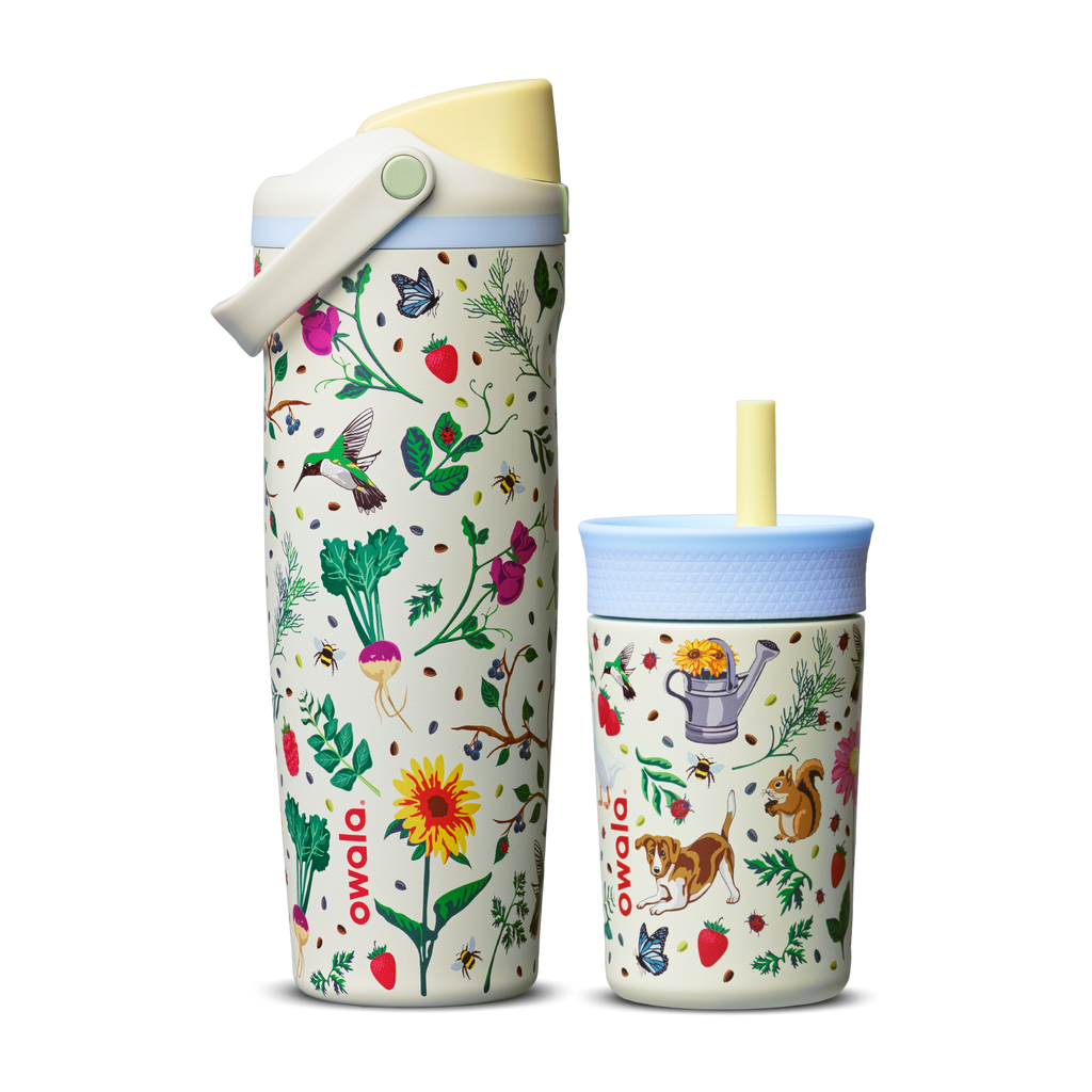 Owala Mother's Day Garden FreeSip Sway and Kids' Tumbler side by side; both in cream white with colorful garden print of flowers, strawberries, hummingbirds, bees, and a squirrel; FreeSip Sway has a yellow flip cap and light blue carry loop, Kids' Tumbler has a light blue lid and yellow straw