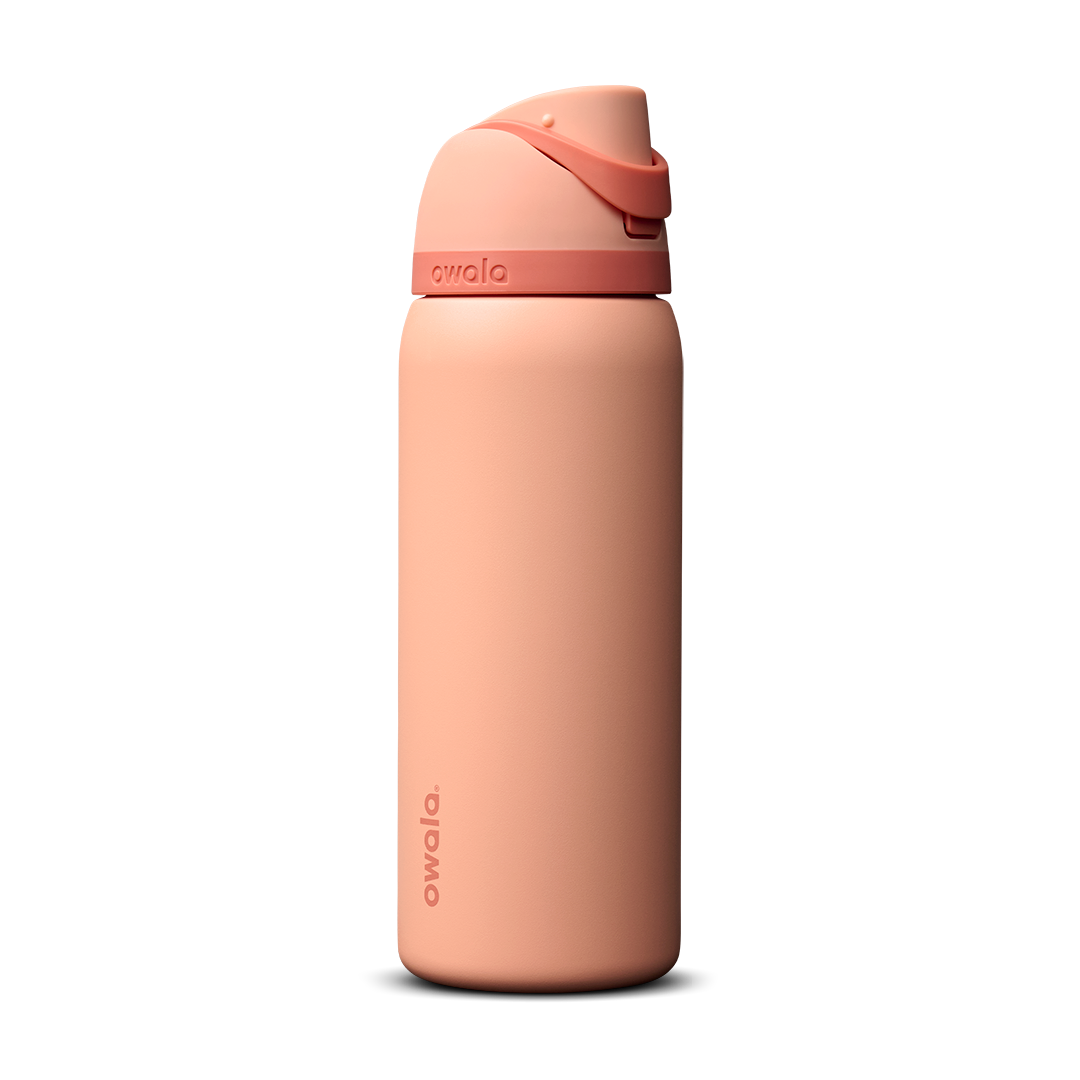 Owala FreeSip 32oz in Peach of Mind, soft coral peach insulated bottle with matching peach flip cap and carry loop