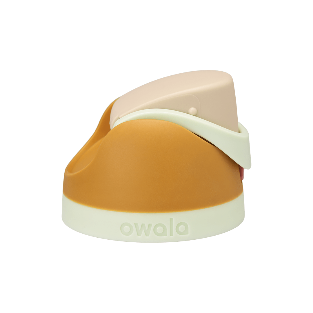 Owala FreeSip replacement lid in Water in the Desert, warm amber golden yellow body with cream beige flip cap and pale mint green carry loop and base accent band