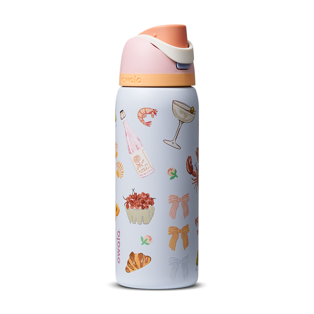 FreeSip 32oz in Picnic Prep, light periwinkle blue body with scattered picnic-themed print (croissants bows cocktail glasses) and peach-salmon flip cap