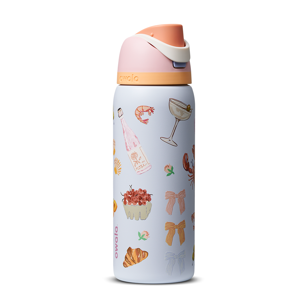 FreeSip 32oz in Picnic Prep, light periwinkle blue body with scattered picnic-themed print (croissants bows cocktail glasses) and peach-salmon flip cap