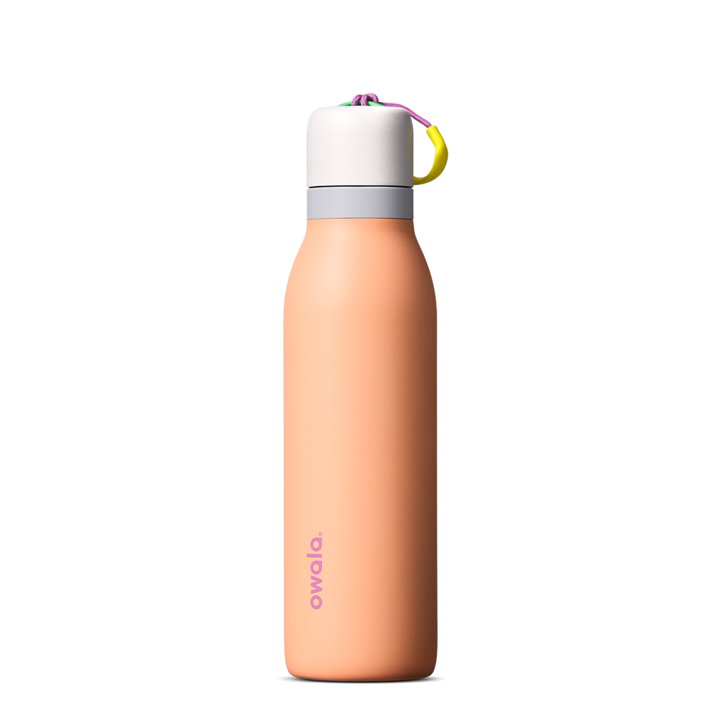 FreeSip Twist 18oz in Peachy Keen (soft coral-peach) with a light grey lid and multicolor loop accent, shown