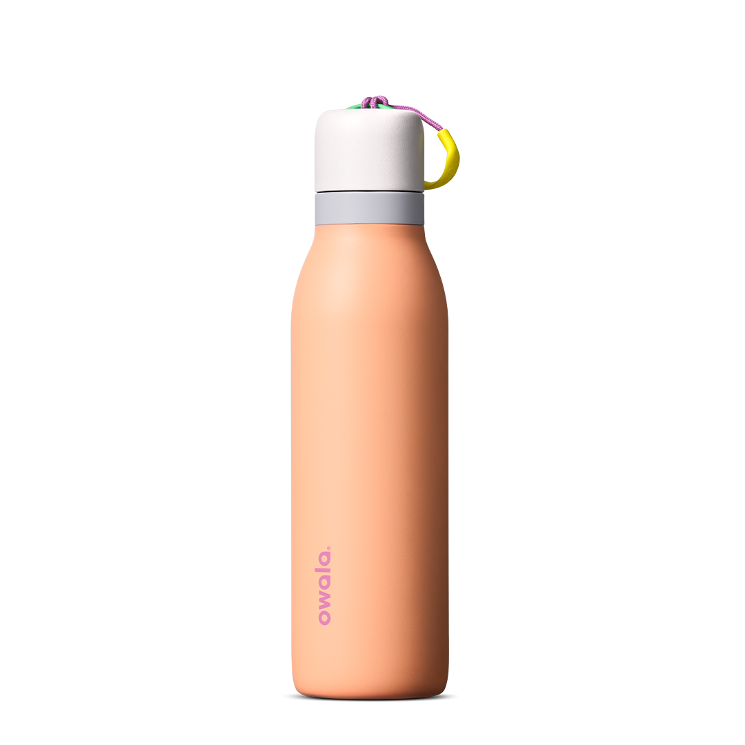FreeSip Twist 18oz in Peachy Keen (soft coral-peach) with a light grey lid and multicolor loop accent, shown