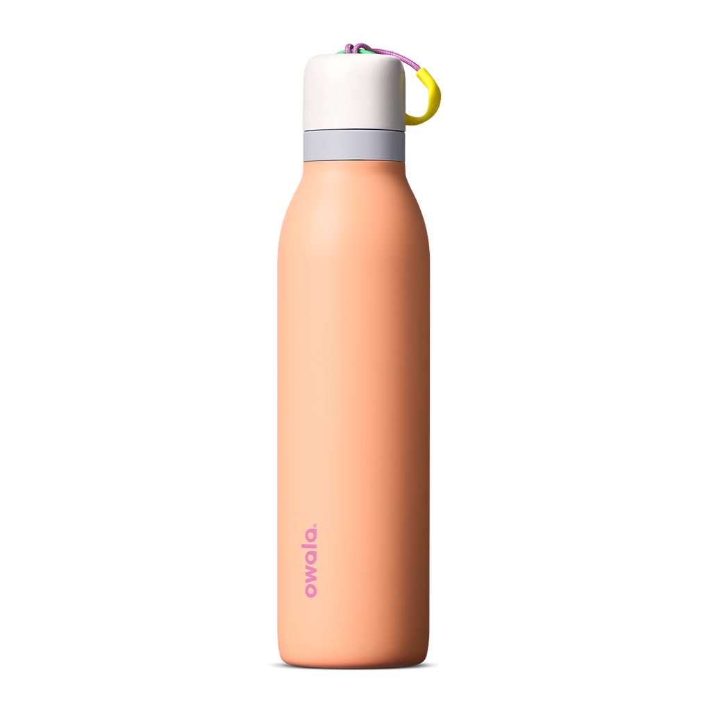 FreeSip Twist 24oz in Peachy Keen (soft coral-peach) with a light grey lid and multicolor loop accent, shown