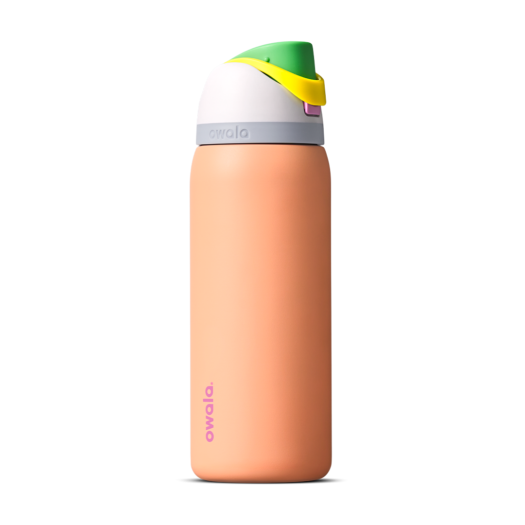 FreeSip 32oz in Peachy Keen, soft peach orange insulated bottle with white flip cap lid, yellow flip tab, and bright green carry loop