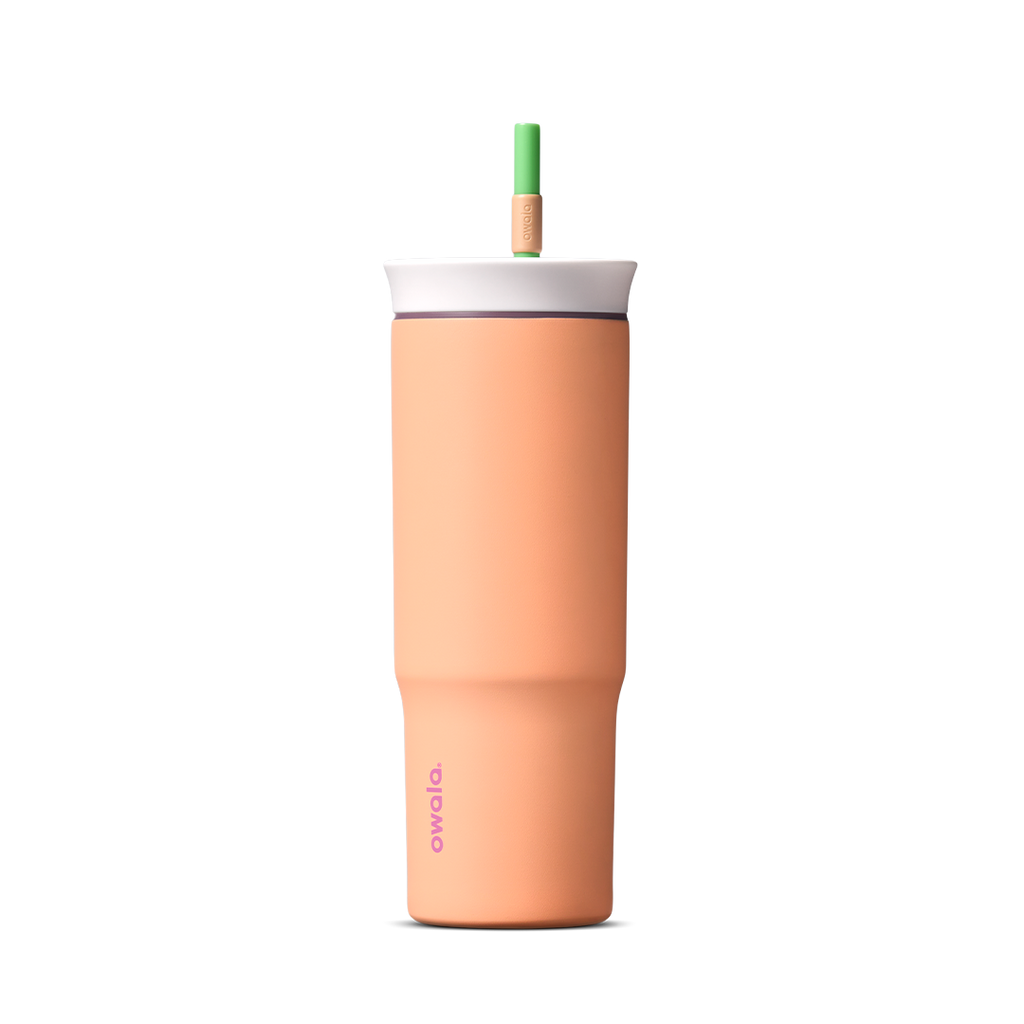 24oz Tumbler in Peachy Keen; matte peach-orange insulated tumbler with white lid and green straw, Owala wordmark on front