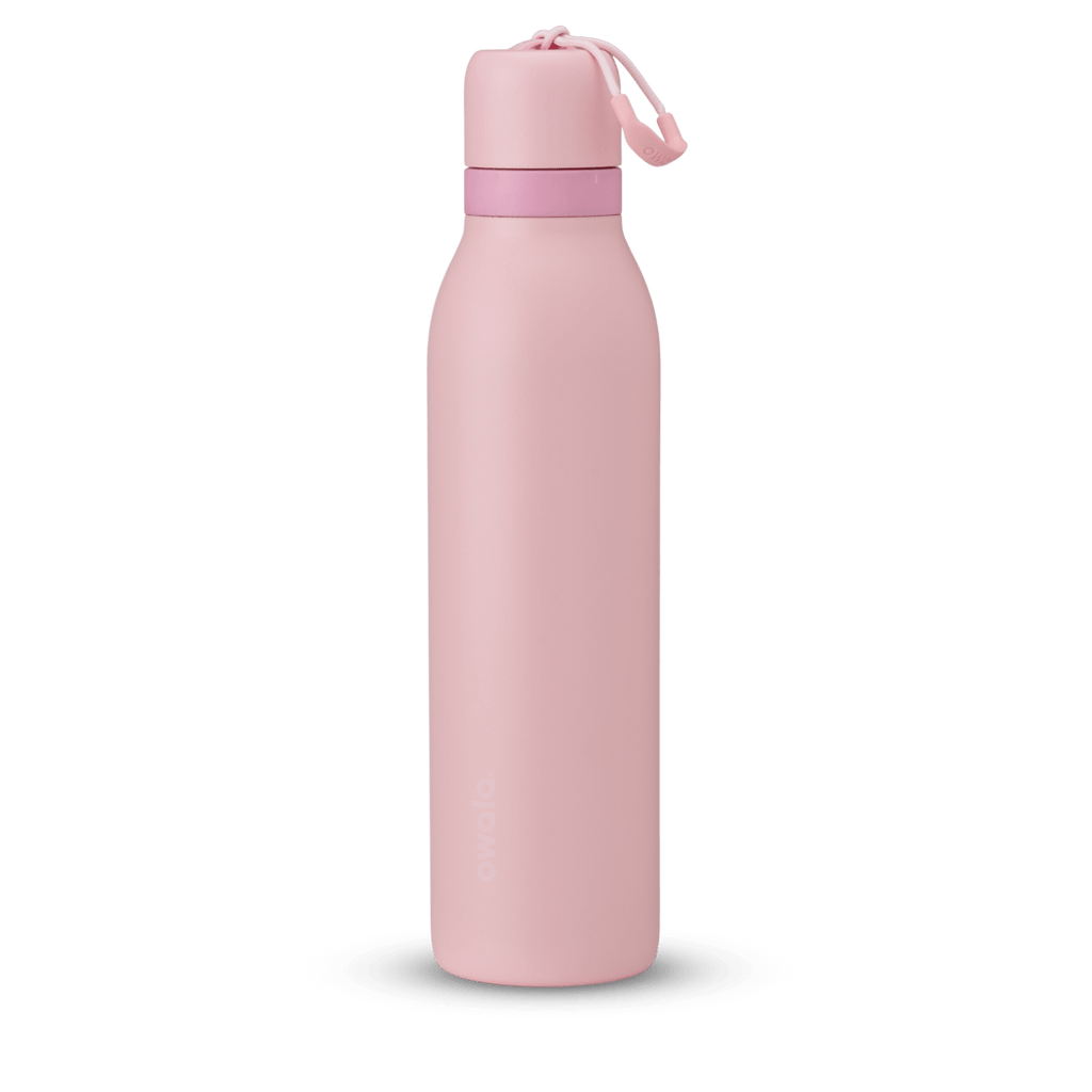 FreeSip Twist 24oz in Rose Quartz, soft pink insulated water bottle with matching pink twist cap, light pink twist cap accent band, and pink carry string with grip
