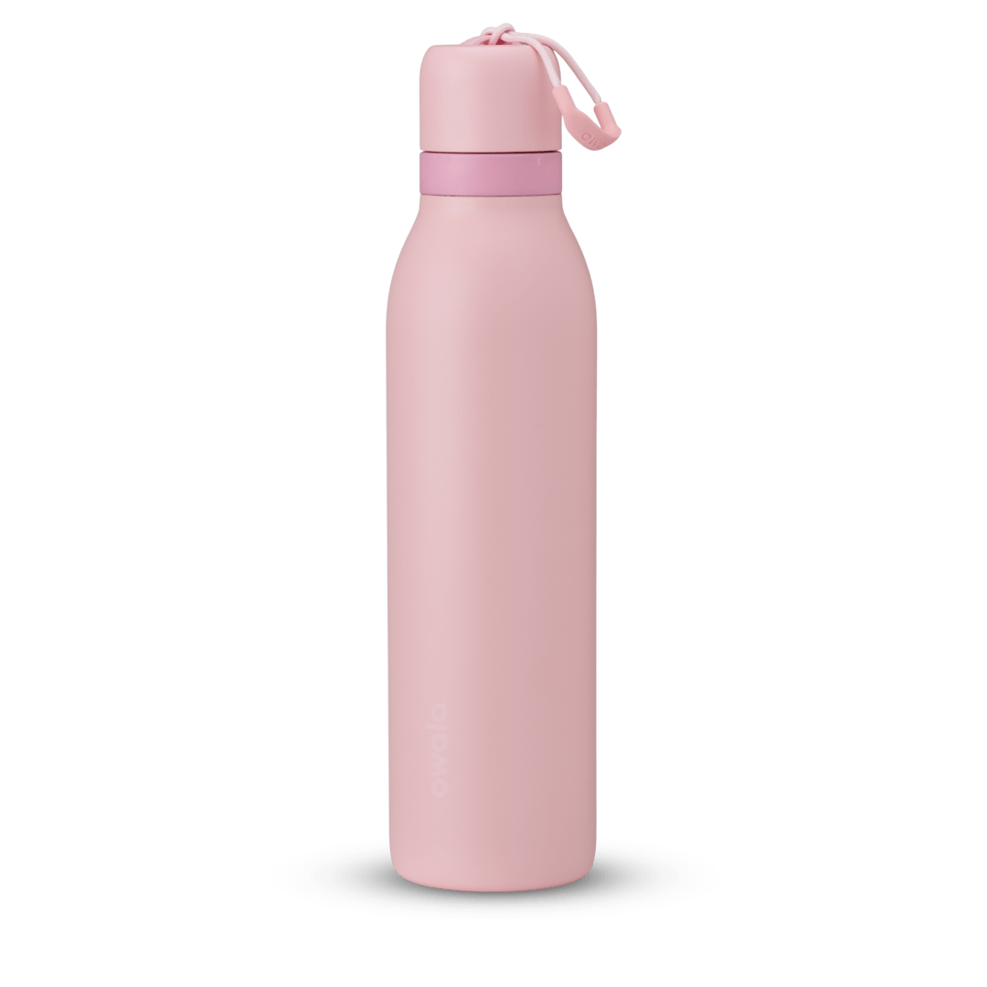 FreeSip Twist 24oz in Rose Quartz, soft pink insulated water bottle with matching pink twist cap, light pink twist cap accent band, and pink carry string with grip