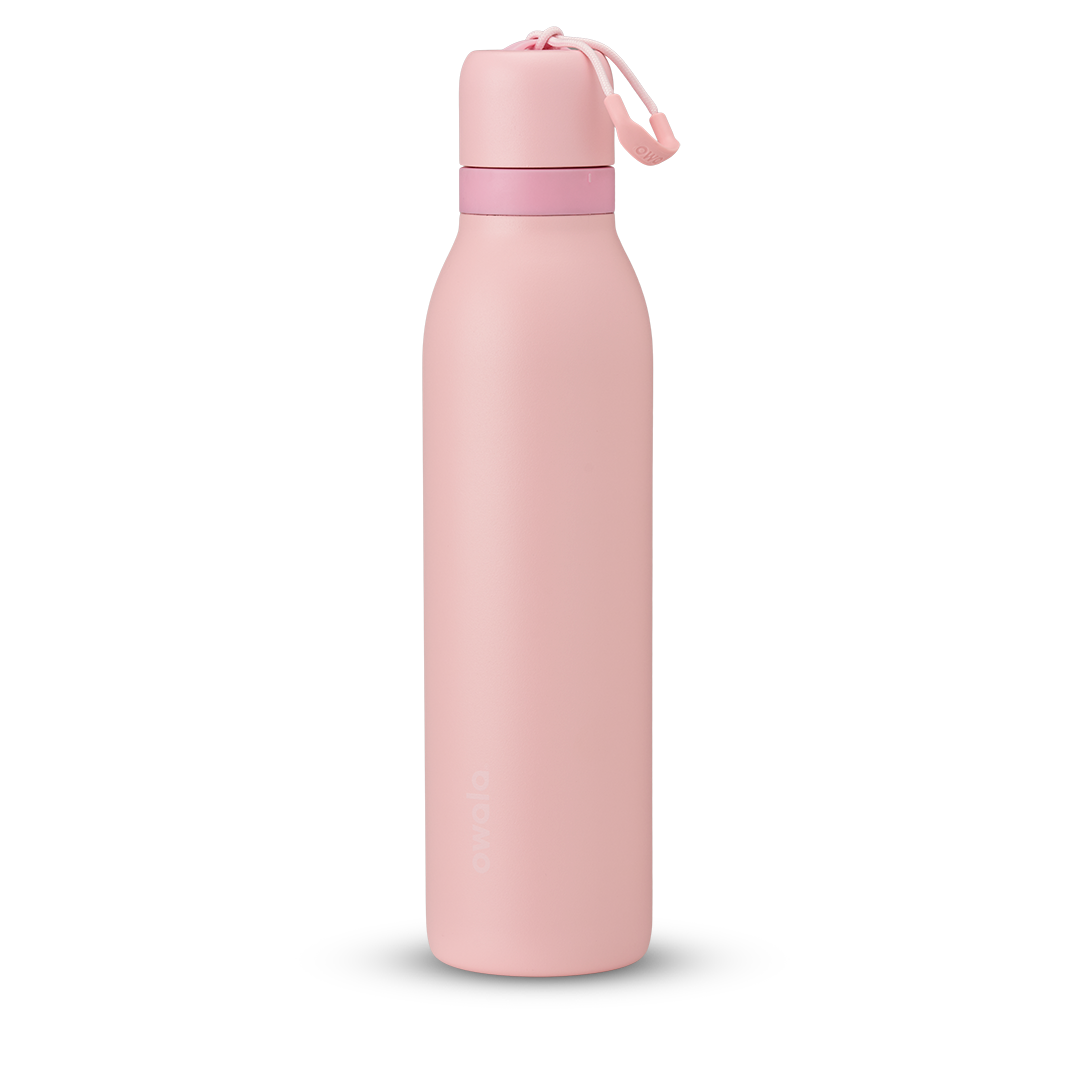 FreeSip Twist 24oz in Rose Quartz, soft pink insulated water bottle with matching pink twist cap, light pink twist cap accent band, and pink carry string with grip