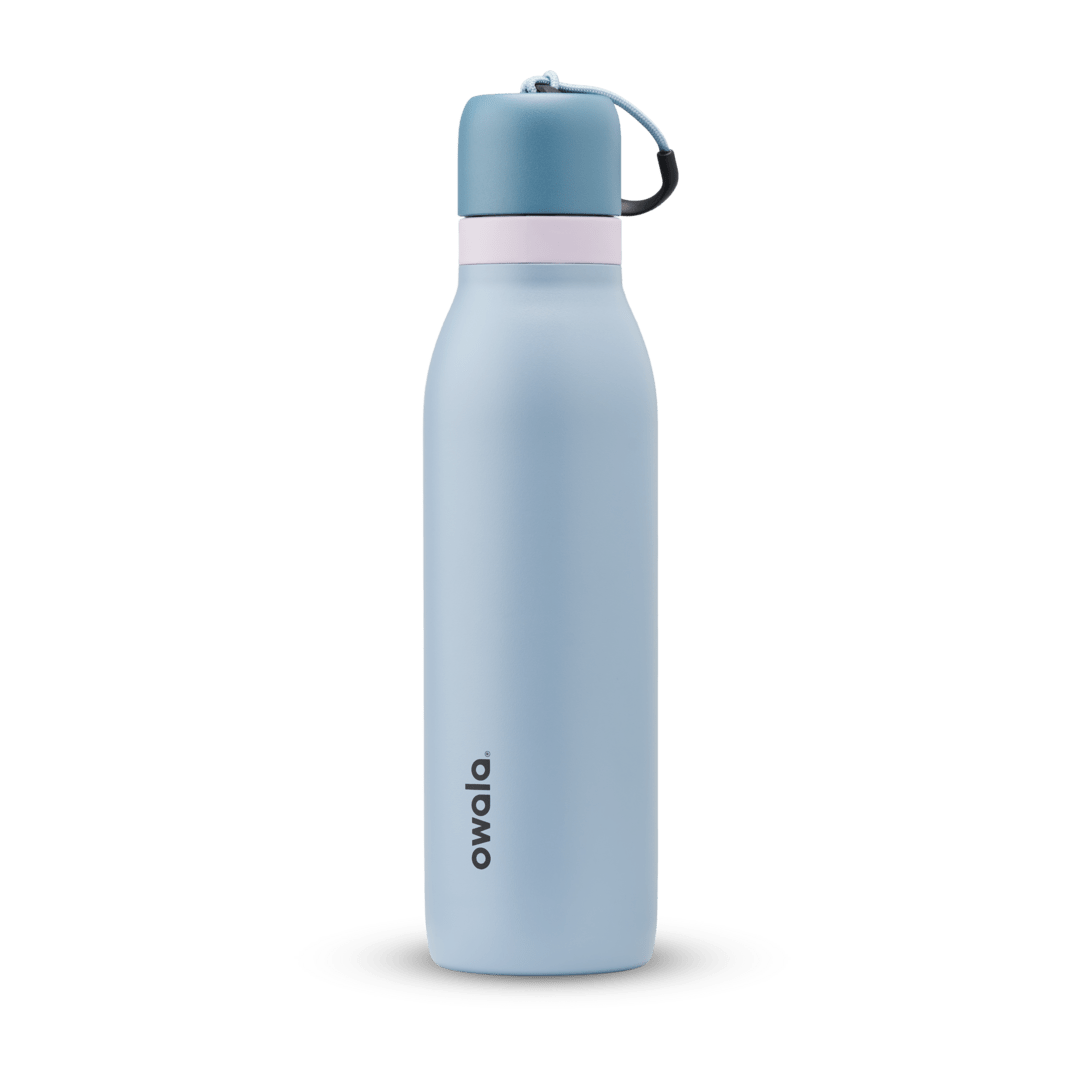 FreeSip Twist 18oz in Rainstorm, light powder blue insulated water bottle with darker slate blue twist cap, pale pink twist cap accent band, and dark navy carry string