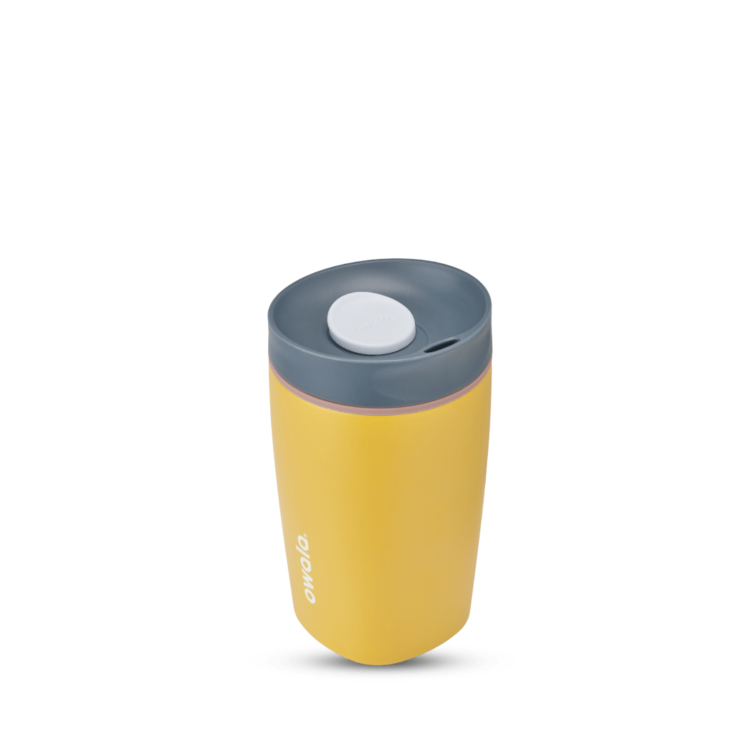 SmoothSip Slider 12oz in Golden Quest, golden yellow body with dark gray lid, white slider button, pale pink accent ring, and white Owala logo