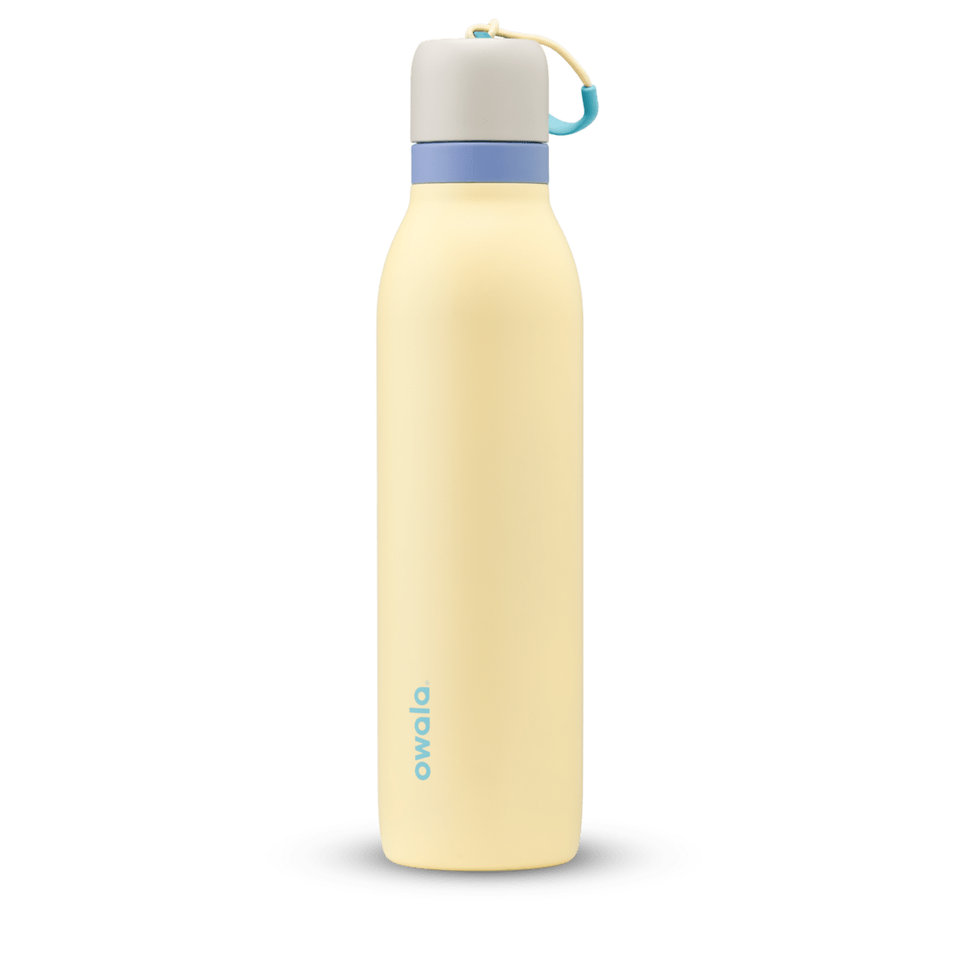 FreeSip Twist 24oz in Sunny Daze, pale yellow insulated water bottle with light gray twist cap, periwinkle blue twist cap accent band, and teal carry string with grip