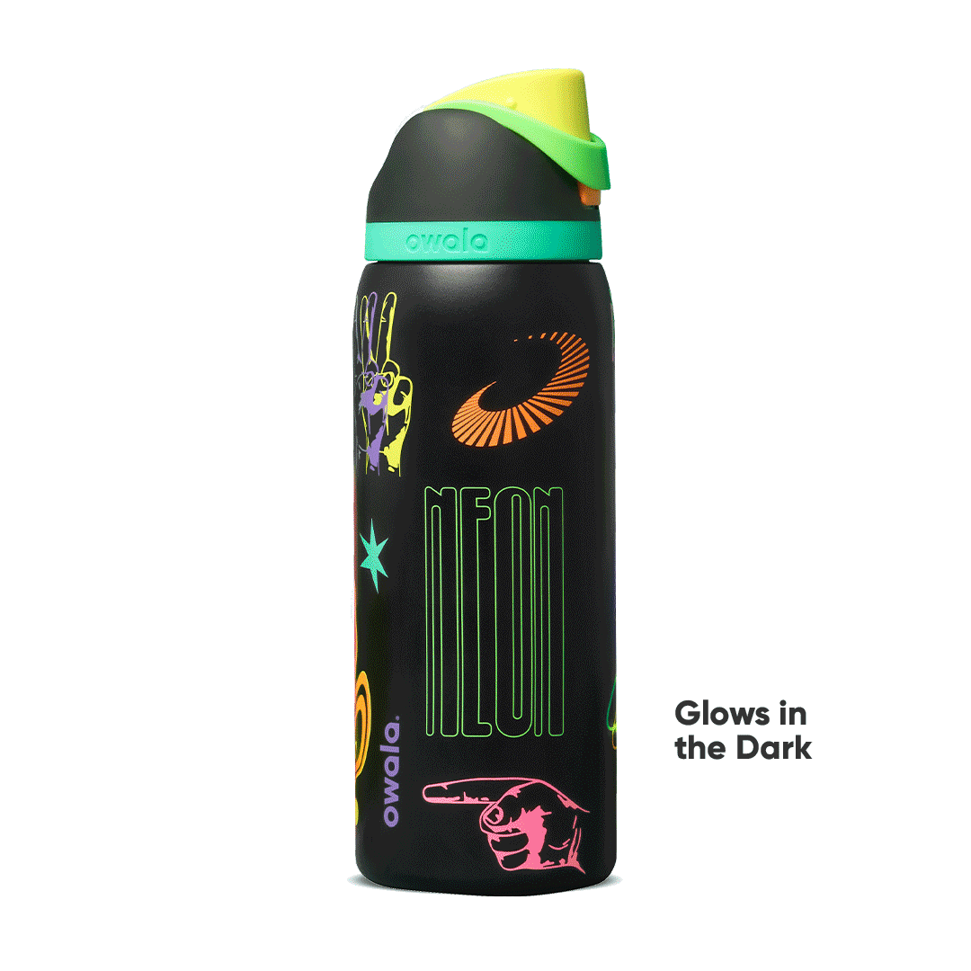 FreeSip 32oz in All Systems Glow, matte black body with neon graphic patches and mint green flip cap; glows in the dark